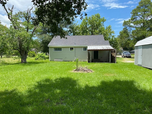 rear view of property with a lawn