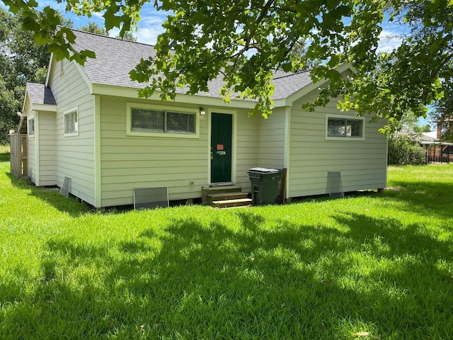 rear view of property with a lawn