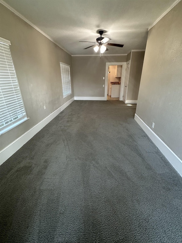 carpeted spare room featuring a textured ceiling, ceiling fan, and ornamental molding