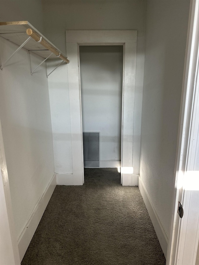 spacious closet featuring dark colored carpet