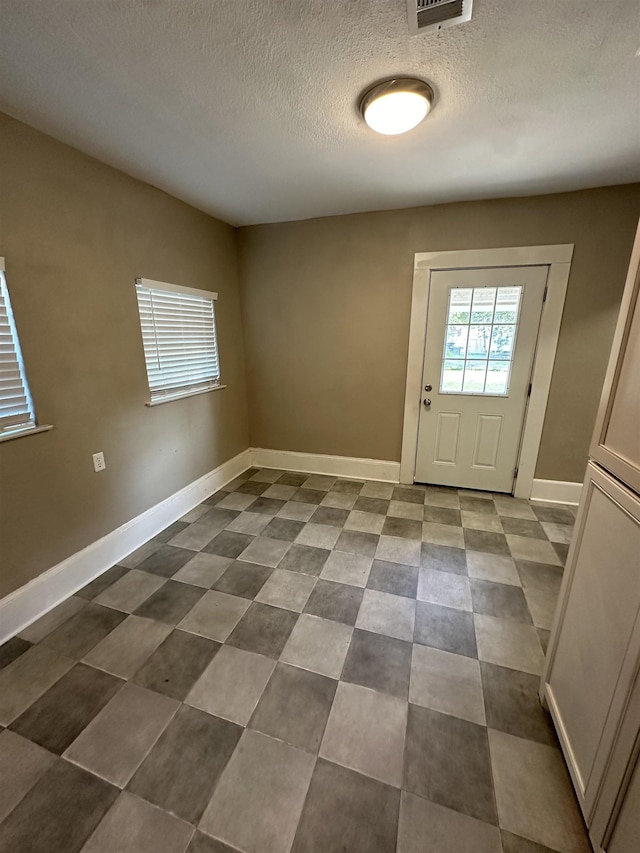 doorway featuring a textured ceiling