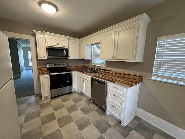 kitchen with white cabinetry, sink, and appliances with stainless steel finishes