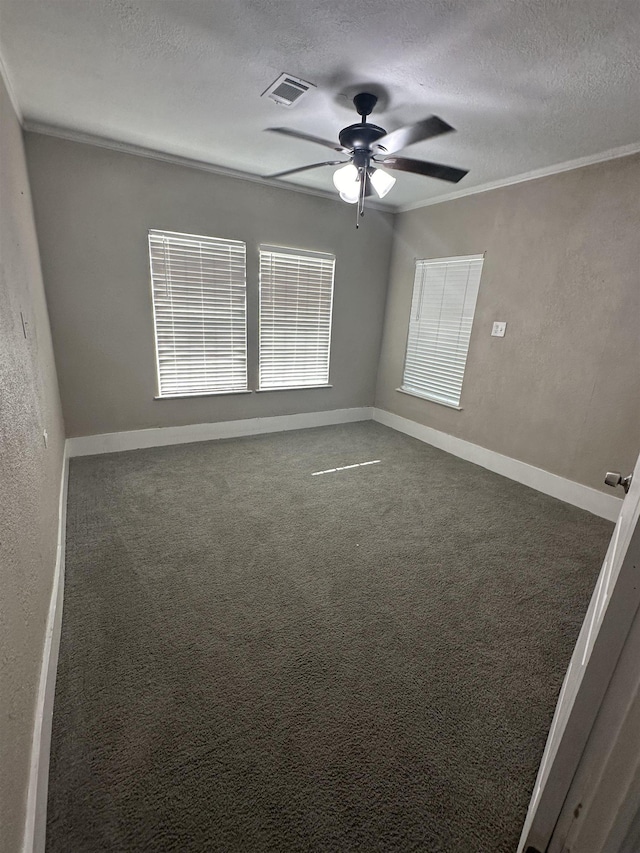 carpeted spare room featuring crown molding, ceiling fan, and a textured ceiling