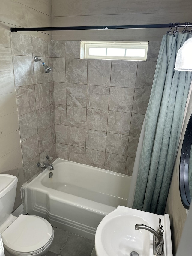 full bathroom with tile patterned flooring, shower / bath combo, toilet, and sink