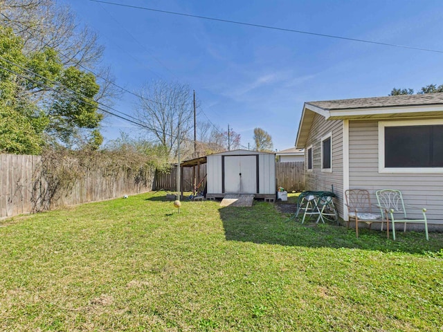 view of yard with a shed, an outdoor structure, and a fenced backyard