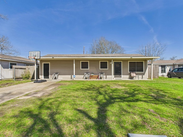 back of house featuring a patio area, fence, and a lawn