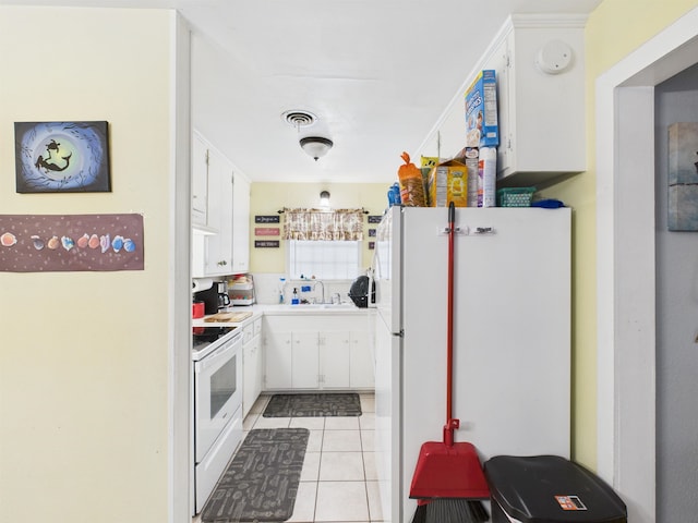 kitchen featuring light tile patterned floors, visible vents, white cabinets, a sink, and white appliances