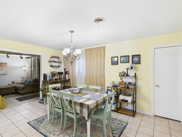 dining space with visible vents, a notable chandelier, baseboards, and light tile patterned flooring