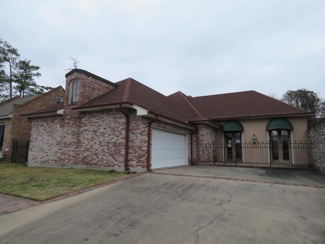 ranch-style house with a front lawn and a garage