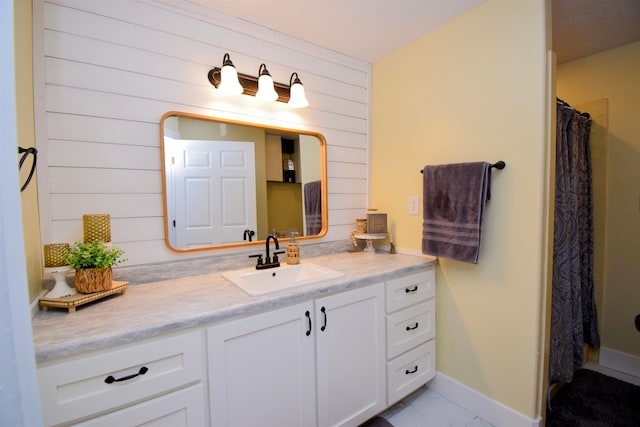 bathroom featuring a shower with shower curtain, vanity, wooden walls, and tile patterned flooring