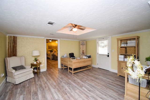 office featuring ornamental molding, a textured ceiling, and light wood-type flooring