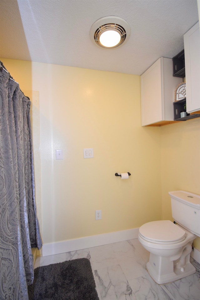 bathroom with toilet and a shower with shower curtain