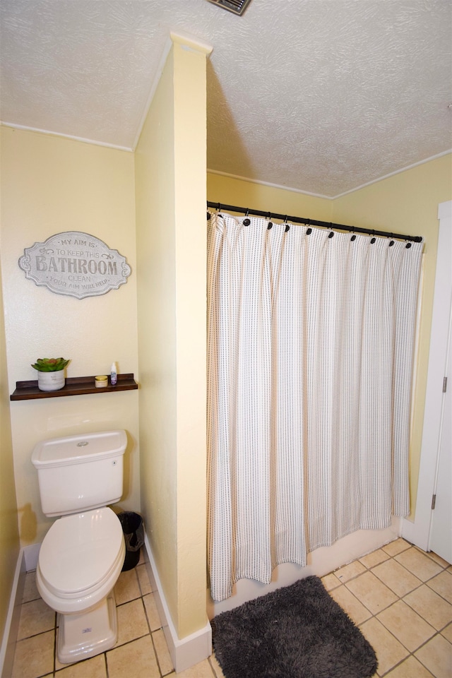 bathroom with tile patterned floors, a textured ceiling, and toilet