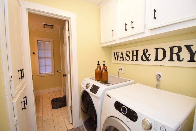 washroom with cabinets, separate washer and dryer, and light tile patterned floors