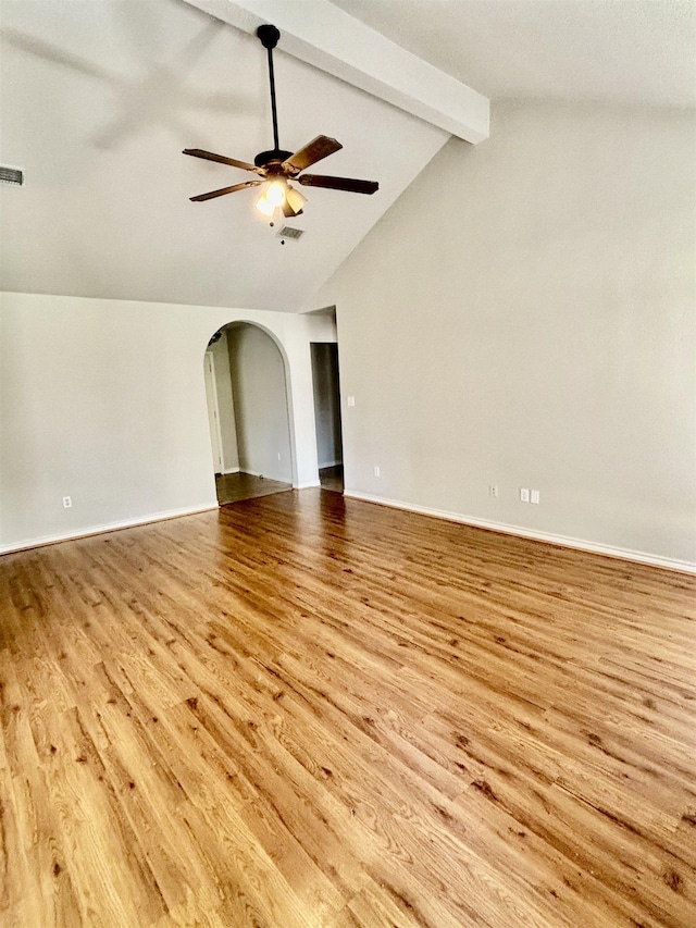 spare room with lofted ceiling with beams, light hardwood / wood-style floors, and ceiling fan