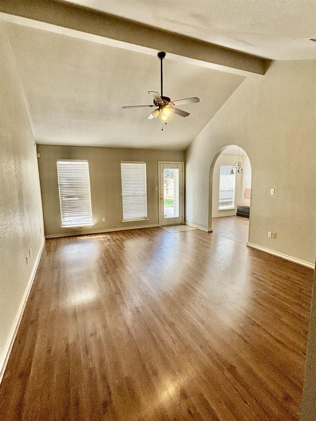 unfurnished living room featuring ceiling fan, lofted ceiling with beams, and dark hardwood / wood-style floors