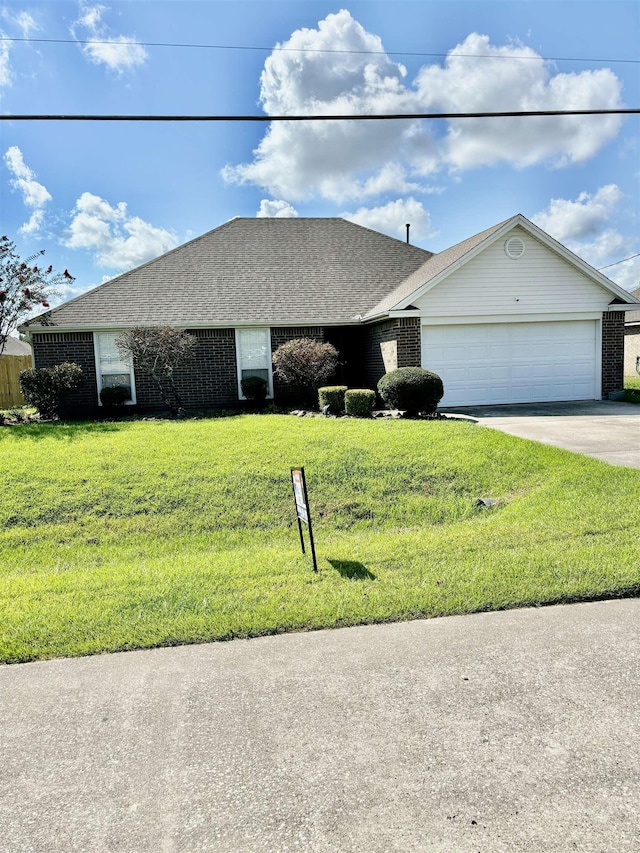 ranch-style home featuring a front lawn and a garage