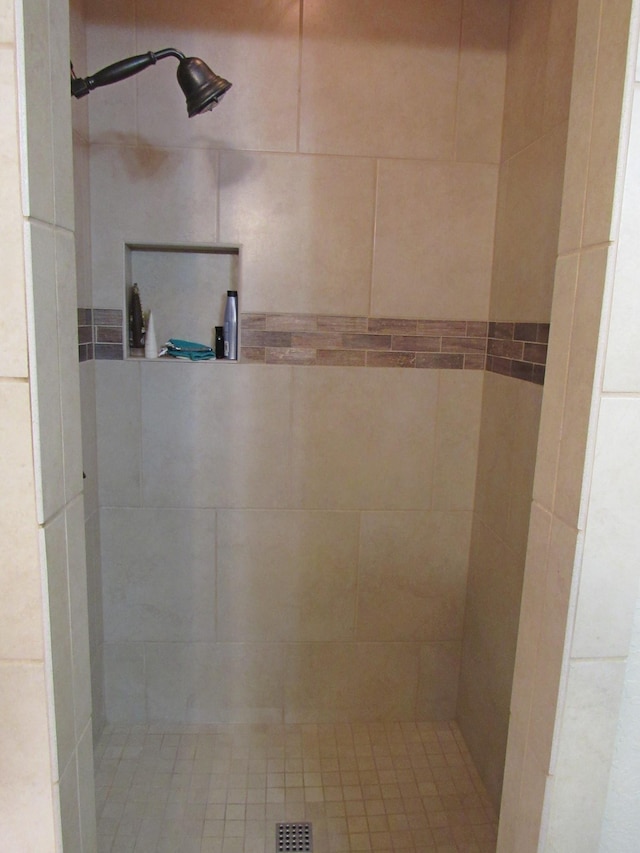 bathroom with a tile shower