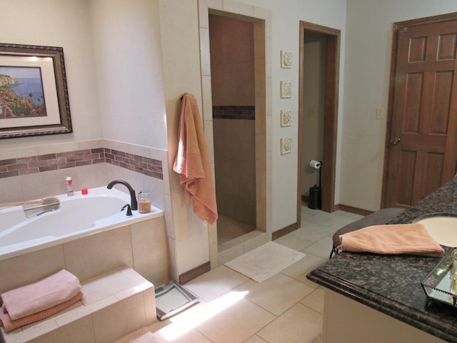 bathroom with shower with separate bathtub, vanity, and tile patterned floors