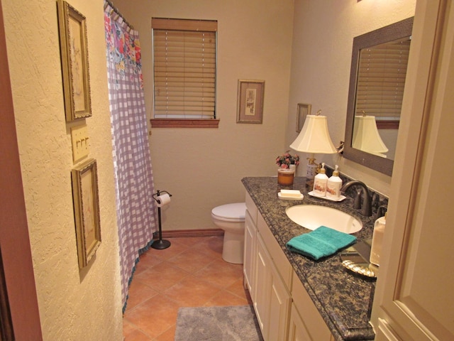 bathroom with tile patterned floors, vanity, and toilet