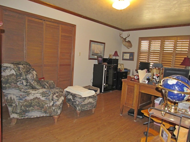 home office with wood-type flooring and crown molding