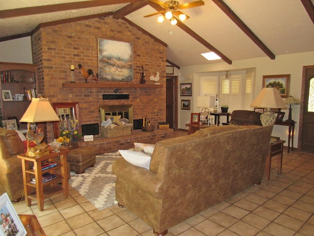 tiled living room with vaulted ceiling with beams, ceiling fan, and a fireplace