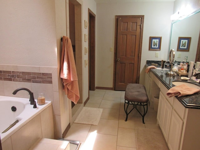 bathroom with vanity, tile patterned floors, and a bathtub