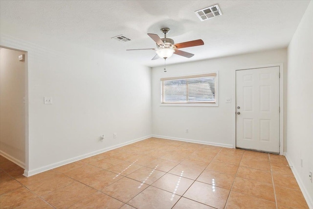 unfurnished room featuring light tile patterned floors and ceiling fan