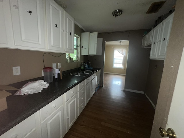 2007 Queen Ave, Nederland, TX 77627 - kitchen with dark wood-style flooring, white cabinetry, and dark countertops