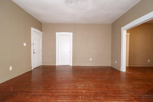 spare room with dark hardwood / wood-style floors