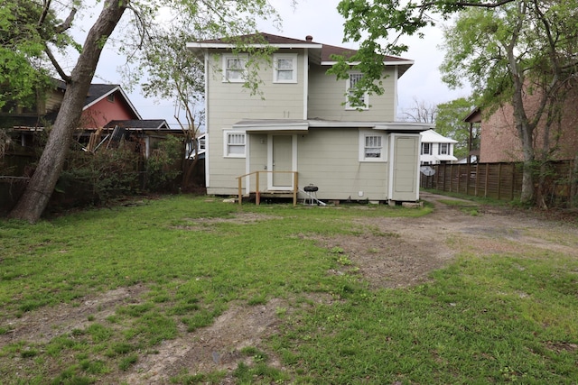 rear view of house with a lawn