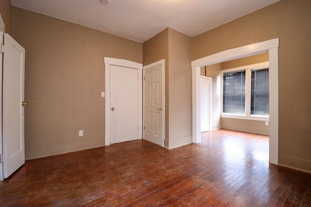 spare room featuring dark wood-type flooring