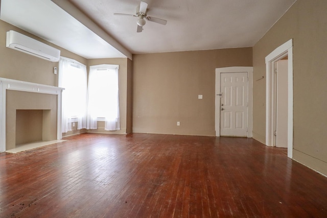 unfurnished living room featuring wood-type flooring, ceiling fan, and a wall unit AC