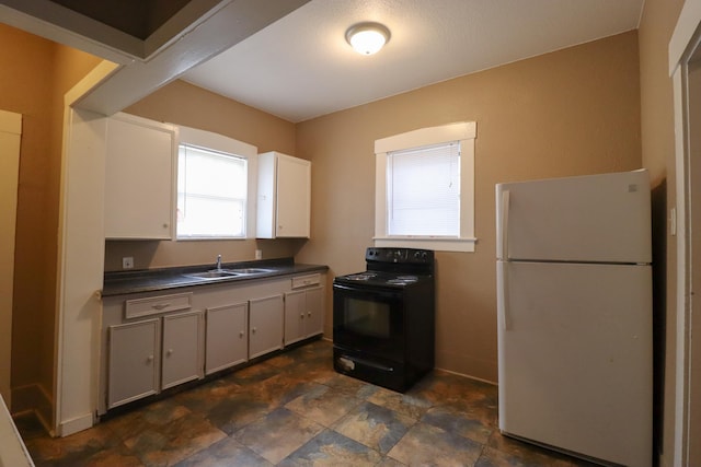 kitchen featuring white refrigerator, black electric range oven, sink, and white cabinets