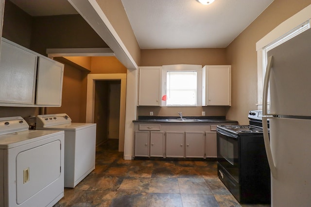 laundry area with washing machine and dryer and sink