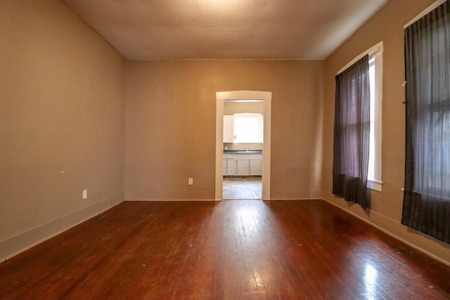 spare room with dark hardwood / wood-style floors