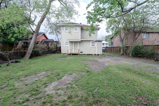 back of property featuring a yard