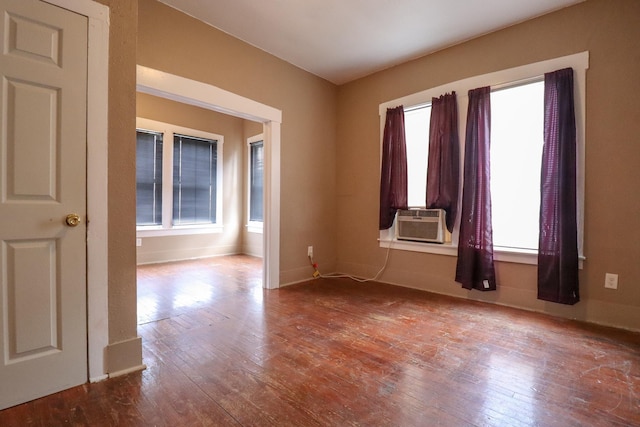 spare room with cooling unit and hardwood / wood-style flooring