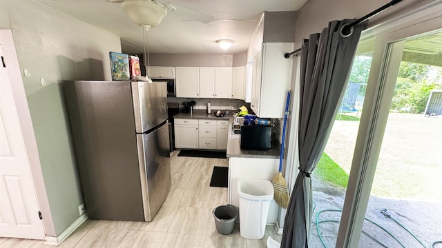 3575 Cecil Dr, Beaumont, TX 77706 - kitchen featuring appliances with stainless steel finishes, white cabinets, backsplash, and dark countertops