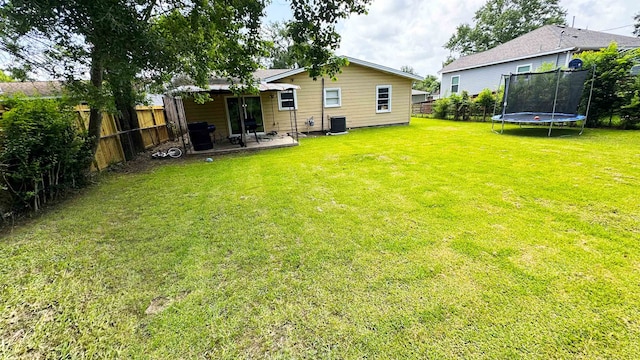 3575 Cecil Dr, Beaumont, TX 77706 - rear view of property with a trampoline, a fenced backyard, and a patio area