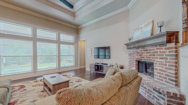6570 Merrick Ln, Beaumont, TX 77706 - living area with wood finished floors, crown molding, a brick fireplace, and a high ceiling