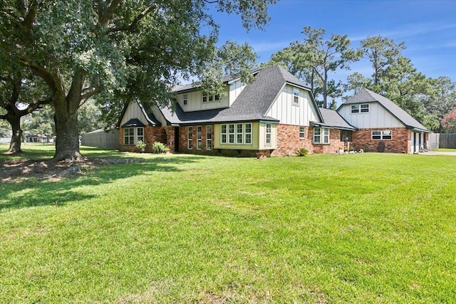 rear view of property featuring a yard