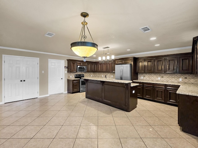 9570 Cumberland Dr, Beaumont, TX 77708 - kitchen with appliances with stainless steel finishes, light tile patterned floors, dark brown cabinetry, tasteful backsplash, and ornamental molding