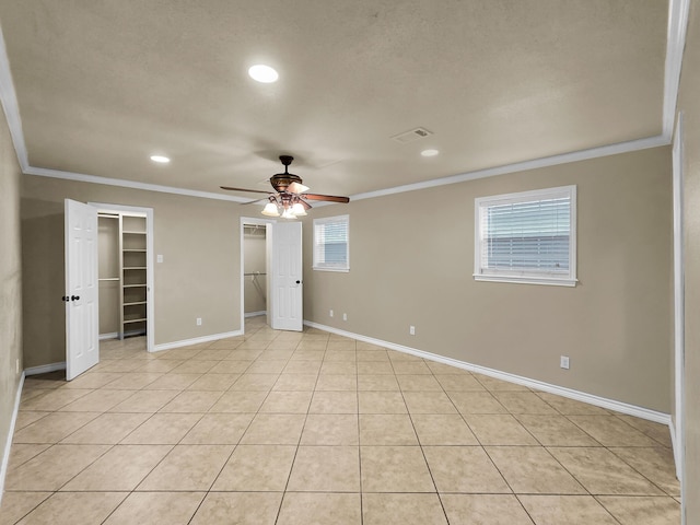 9570 Cumberland Dr, Beaumont, TX 77708 - unfurnished bedroom with crown molding, two closets, recessed lighting, light tile patterned floors, and a ceiling fan