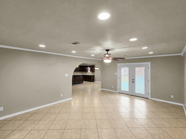 9570 Cumberland Dr, Beaumont, TX 77708 - unfurnished living room featuring ceiling fan, recessed lighting, ornamental molding, arched walkways, and french doors