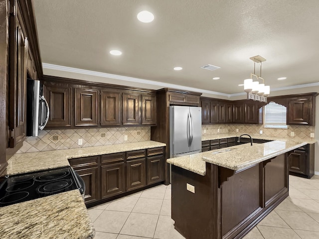 9570 Cumberland Dr, Beaumont, TX 77708 - kitchen with freestanding refrigerator, stainless steel microwave, ornamental molding, dark brown cabinets, and light tile patterned flooring