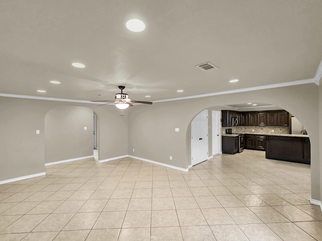 9570 Cumberland Dr, Beaumont, TX 77708 - unfurnished living room with recessed lighting, arched walkways, crown molding, ceiling fan, and light tile patterned flooring