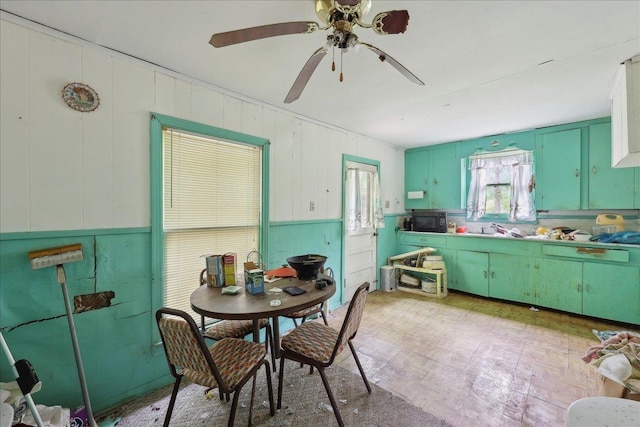dining area featuring a ceiling fan and light floors