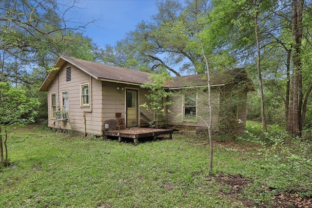 back of house with a lawn