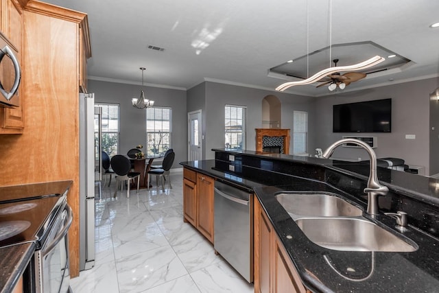 kitchen featuring marble finish floor, a fireplace, stainless steel appliances, visible vents, and a sink